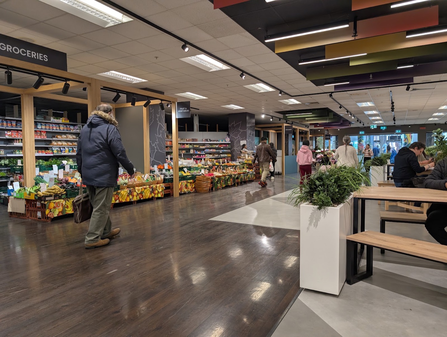 The bright lower-level food hall inside The Exchange Ilford with communal bench seating